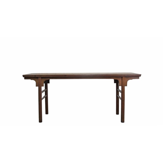 This early-19th century walnut wood table features a flush-panel top with a clean, rectangular silhouette. Constructed...