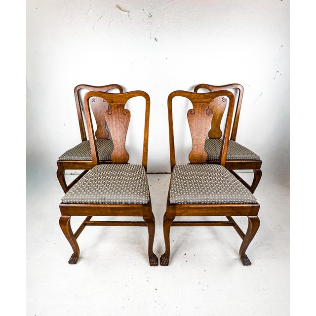 A set of Queen Anne style dining chairs with sweetly subtle detailing on the chair backs.