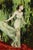 Garden Wind by Nadezda | Oil on Panel Woman in a flowing dress against a green background. For Sale