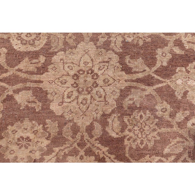 This circa-1920 antique Persian Sultanabad rug features an all-over design of arabesques, floral abstractions and vinery...