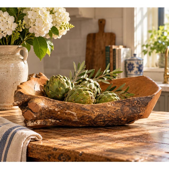 A beautifully sculptural hand-carved wood bowl with a naturally organic silhouette and richly textured live-edge exterior....