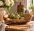 A beautifully sculptural hand-carved wood bowl with a naturally organic silhouette and richly textured live-edge exterior....