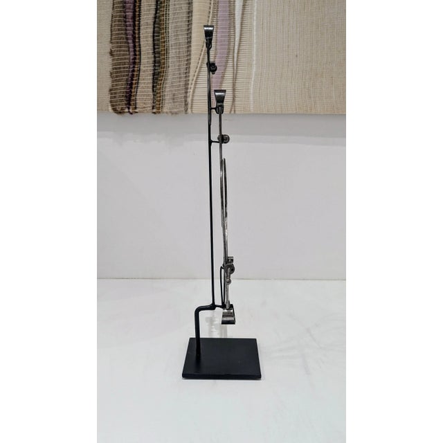 These vintage calipers, mounted on stands, are a symbol of both precision craftsmanship and industrial design history....