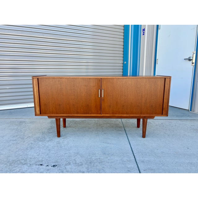 This sleek mid-century modern credenza features clean lines, rich walnut frame, and functional design. Equipped with...