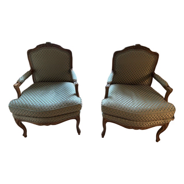 Pair of Vintage French Louis XIV-Style Carved Fauteuil Chairs by Baker Furniture Company. For Sale