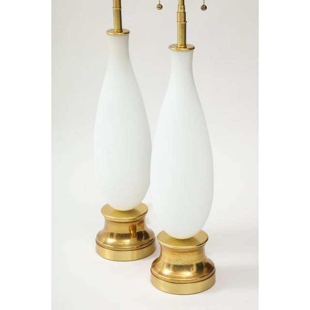 Pair of 1960's frosted murano glass lamps. The glass lamp bodies sit on brass bases and are newly rewired with adjustable...