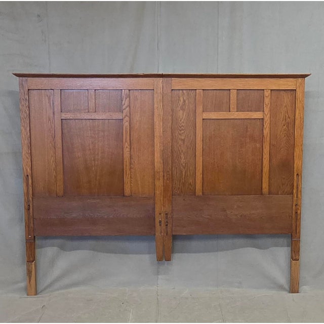 A classic and functional antique oak Arts & Crafts style paneled king size headboard that was created from joining two...