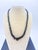 This mid‑century fine jewelry, jet-revival necklace features hand‑faceted natural black onyx beads graduated from 14 mm at...