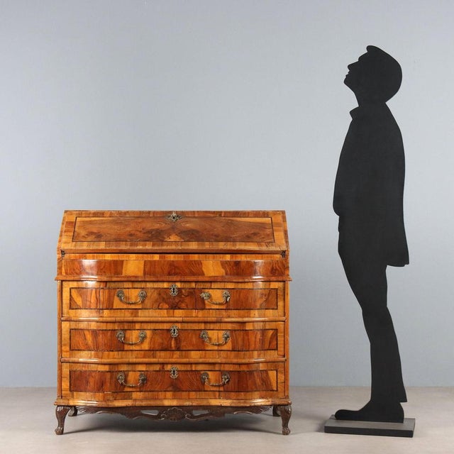 A late Baroque walnut and crotchet drop-leaf chest with rosewood trim. The curved front features three drawers, while the...