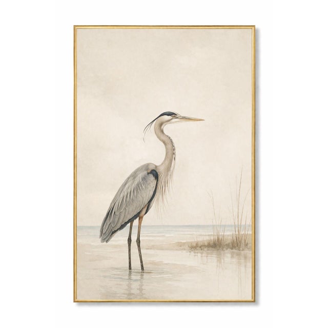 Refined coastal artwork featuring a great blue heron standing in shallow water against a soft, misty shoreline. The...