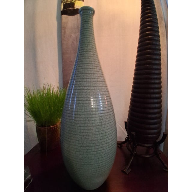 Originating from the renowned ceramic workshops of Portugal, this elegant vessel features a classic modernist silhouette...