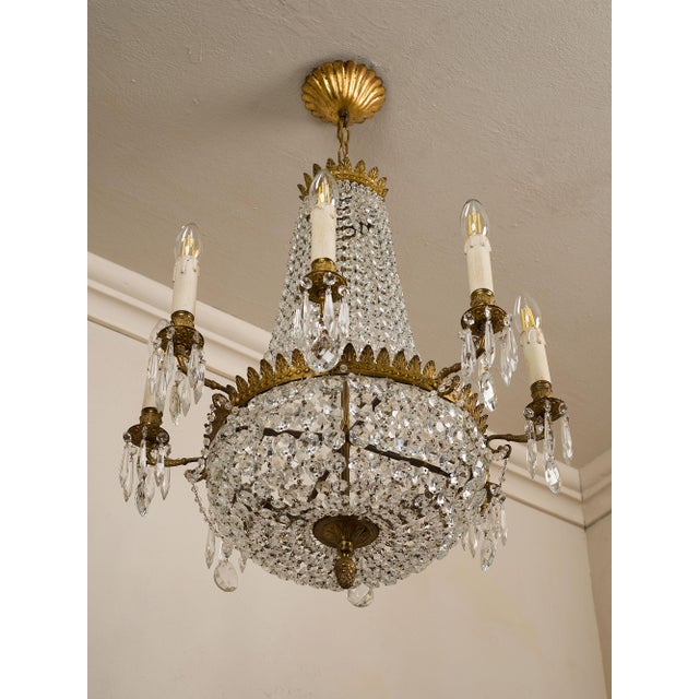 Empire-style chandelier in the shape of a hot air balloon, made in Italy in the 1940s and illuminated by eight lights. The...