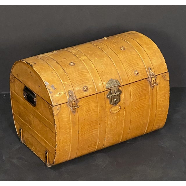 A handsome English dome-topped steamer or traveler's luggage trunk, circa 1858 - 1880, featuring a toleware enameled tin...