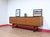 A true mid century classic credenza with stunning style made by renowned British furniture maker White and Newton, this...