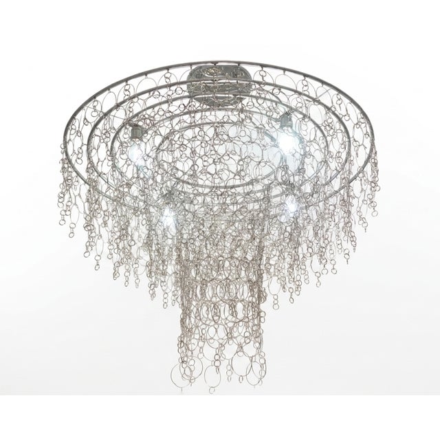Majestic is a monumental luminous sculpture that reinterprets the charm of grand castle chandeliers in a contemporary key....