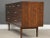 A mid century modern walnut Declaration eight drawer dresser with polished brass knobs designed by Kipp Stewart and...