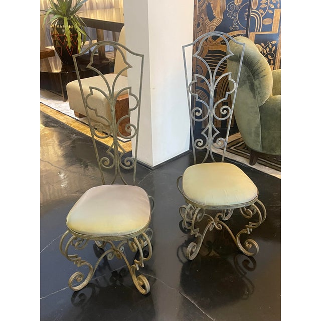Pair of French Art Deco Garden chairs with bronze plated wrought iron chairs. The backs and legs of these chairs feature...
