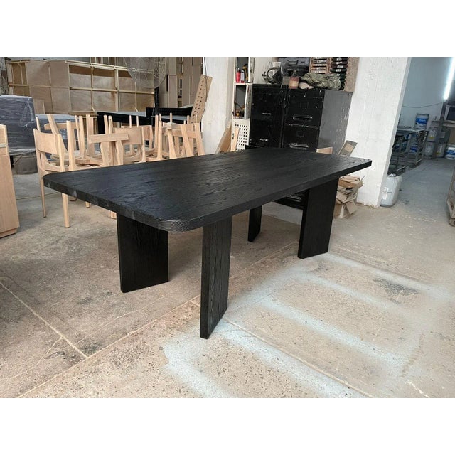Large and very solid wood dining table, in a black wire brush finish. This item was custom made for me and is extremely...