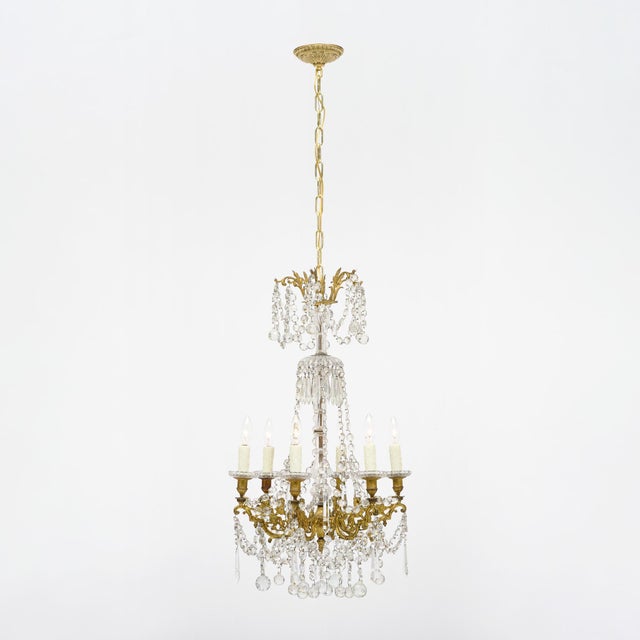 Chandelier from France made with a solid gilt bronze structure by Baccarat. The structure is adorned with crystal elements...