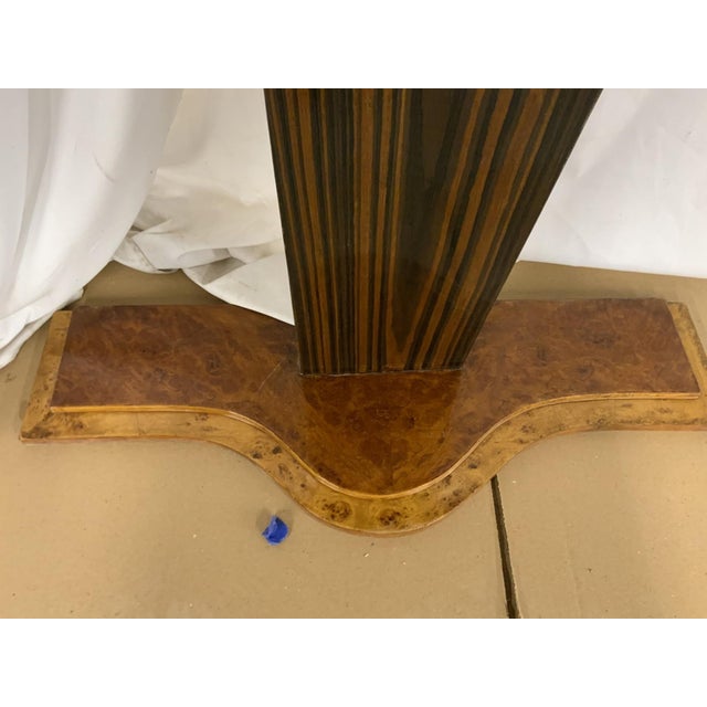 Mid-century Art Deco burl wood console or entry table with a pedestal base and three drawers with silvered brass pulls. No...