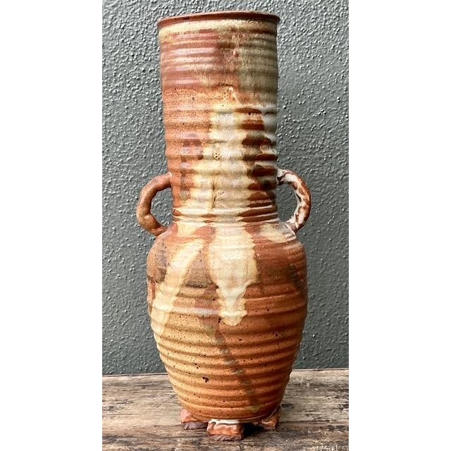 This striking original studio pottery vase is an exceptional example of late 20th-century artisanal craftsmanship....