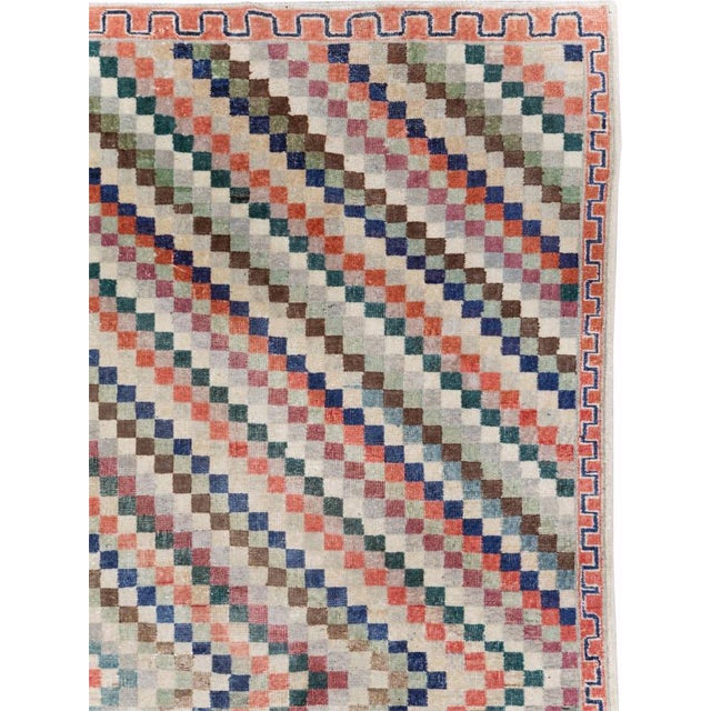 This Mid-20th century Turkish Anatolian Art Deco carpet presents a vibrant geometric composition formed from hundreds of...