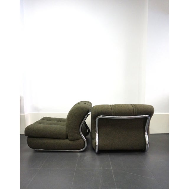Pair of Italian modular armchairs, a 1970s design. The tubular, chromed steel frame encases and supports the cushions....