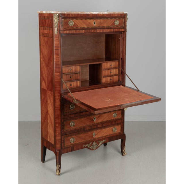 A late 19th century French Louis XVI style secrétaire à abattant, or drop front secretary desk, made with inlaid veneers...