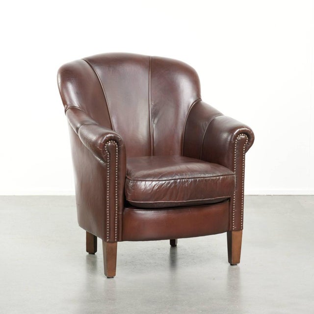This charming and comfortable sheepskin armchair features a beautiful, deep dark color and elegant design, and is finished...