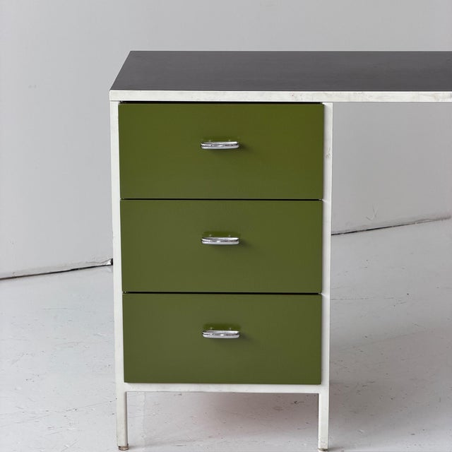 c. 1960s. USA. Laminate top with newly refinished avocado green drawers. Original pulls. Remnants of a table in one...