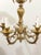 A stunning brass chandelier showcasing intricate engravings in the elegant Art Nouveau style. The design draws clear...