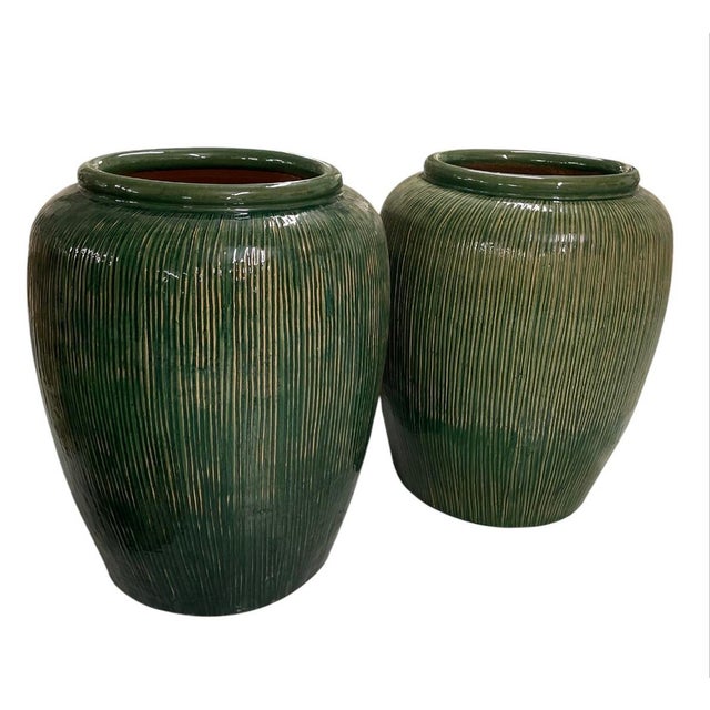 This striking pair of large-scale ceramic planters features a beautifully defined ovoid shape, narrowing gracefully toward...