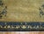 An oversize Chinese Peking rug in tans and blue. Peking rugs consist of designs that are simpler and asymmetrical, often...
