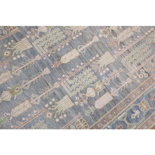 2nd quarter of the century Persian Malayer intermediate-size rug with a weeping tree of life design on a neutral field...