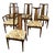 A complete dining set of six mid-century chairs — four side chairs and two armchairs — each built around a tall, tapering...