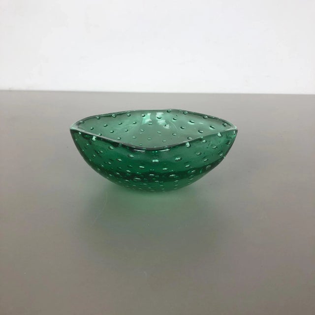 Murano glass bowl, ashtray element Origin: Murano, Italy Decade: 1970s This original glass shell bowl was produced in the...
