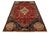 This stunning handmade wool rug showcases a red field adorned with navy blue and multicolored tribal designs. This rug...