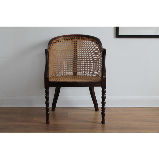 Add a touch of vintage charm to your home with this classic cane armchair. Featuring a beautifully handwoven rattan back...