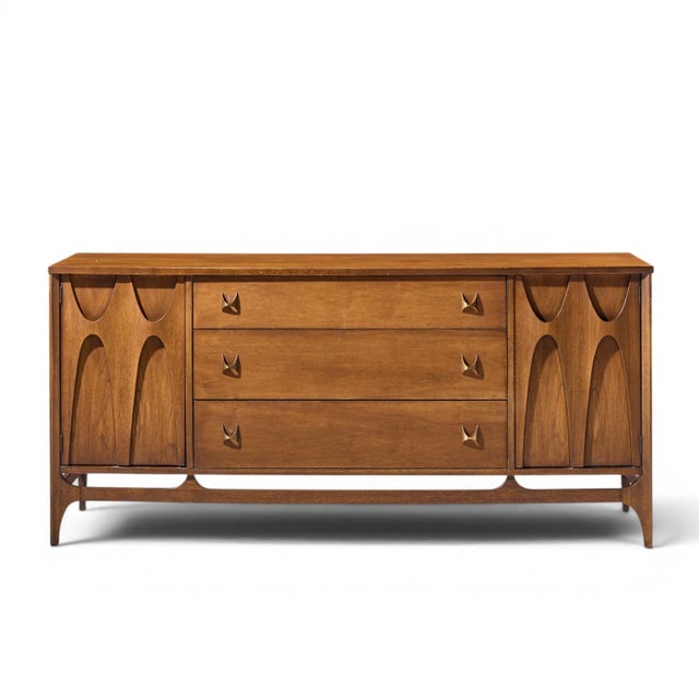 Broyhill Brasilia Mid Century Walnut and Brass 66 Inch Credenza This credenza measures: 66 wide x 19 deep x 30.75 inches...