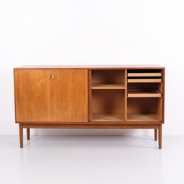 Danish design sideboard from the 1960s made of teak. The sideboard features sliding doors with interior drawers and...