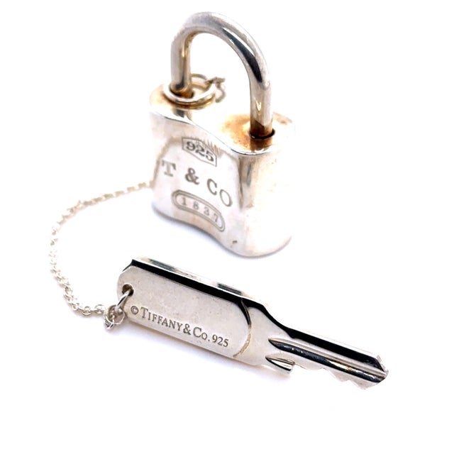 A rare Tiffany & Co. 1837 padlock key chain crafted in sterling silver, featuring a distinctive padlock motif engraved...