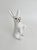 This antique French rabbit features hand-painted details and glass eyes on the "faience" white glazed terracotta...