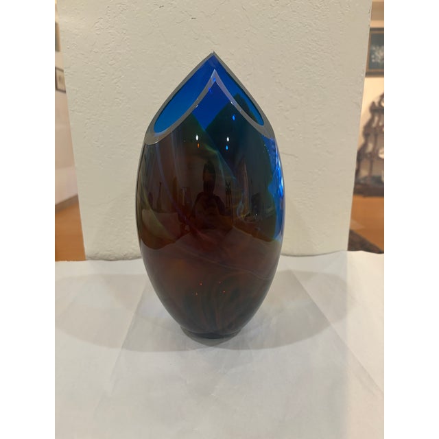 A dramatic studio art-glass vase by American glass artist Peter VanderLaan. The elongated ovoid body is formed in deep...