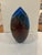 A dramatic studio art-glass vase by American glass artist Peter VanderLaan. The elongated ovoid body is formed in deep...