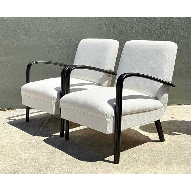 This sophisticated pair of vintage Mid-Century Modern lounge chairs exemplifies the clean lines and sculptural elegance...