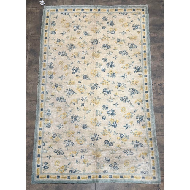 This charming 1920s Portuguese rug features a delicate allover floral composition rendered in a beautifully restrained...