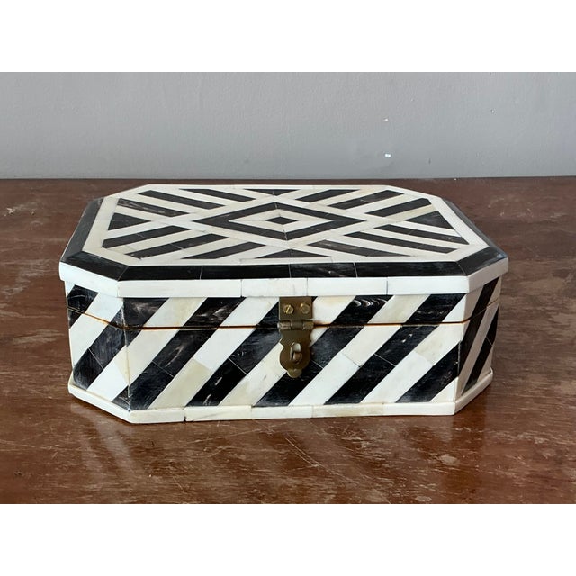 This striking vintage octagonal box features an exquisite tessellated bone inlay design, exuding a chic bohemian aesthetic...