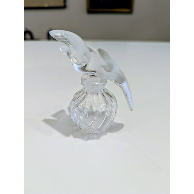 Vintage Nina Ricci L’Air du Temps perfume bottle with frosted crystal dove stopper and fluted clear base. Designed by Rene...