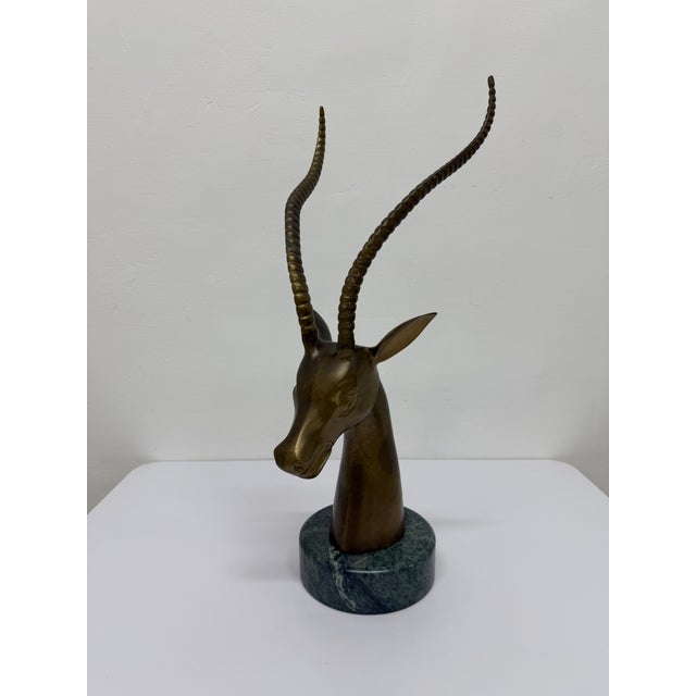 Mid-Century brass sculpture of a gazelle on top of a variegated Italian green marble base circa 1960s/1970s.