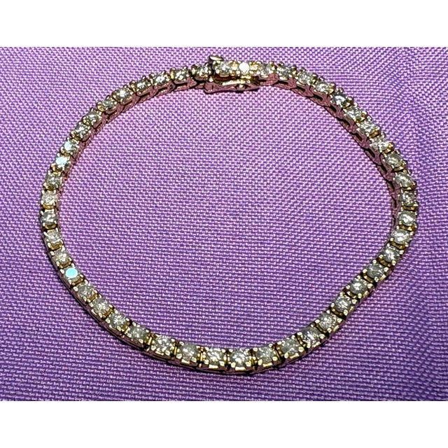 Enjoy this classic beauty, ladies 14K yellow gold diamond tennis bracelet with 47 round brilliant cut diamonds in 4prong...